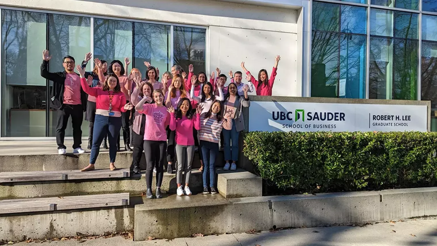 Pink Shirt Group Photo - Hands Up.webp 